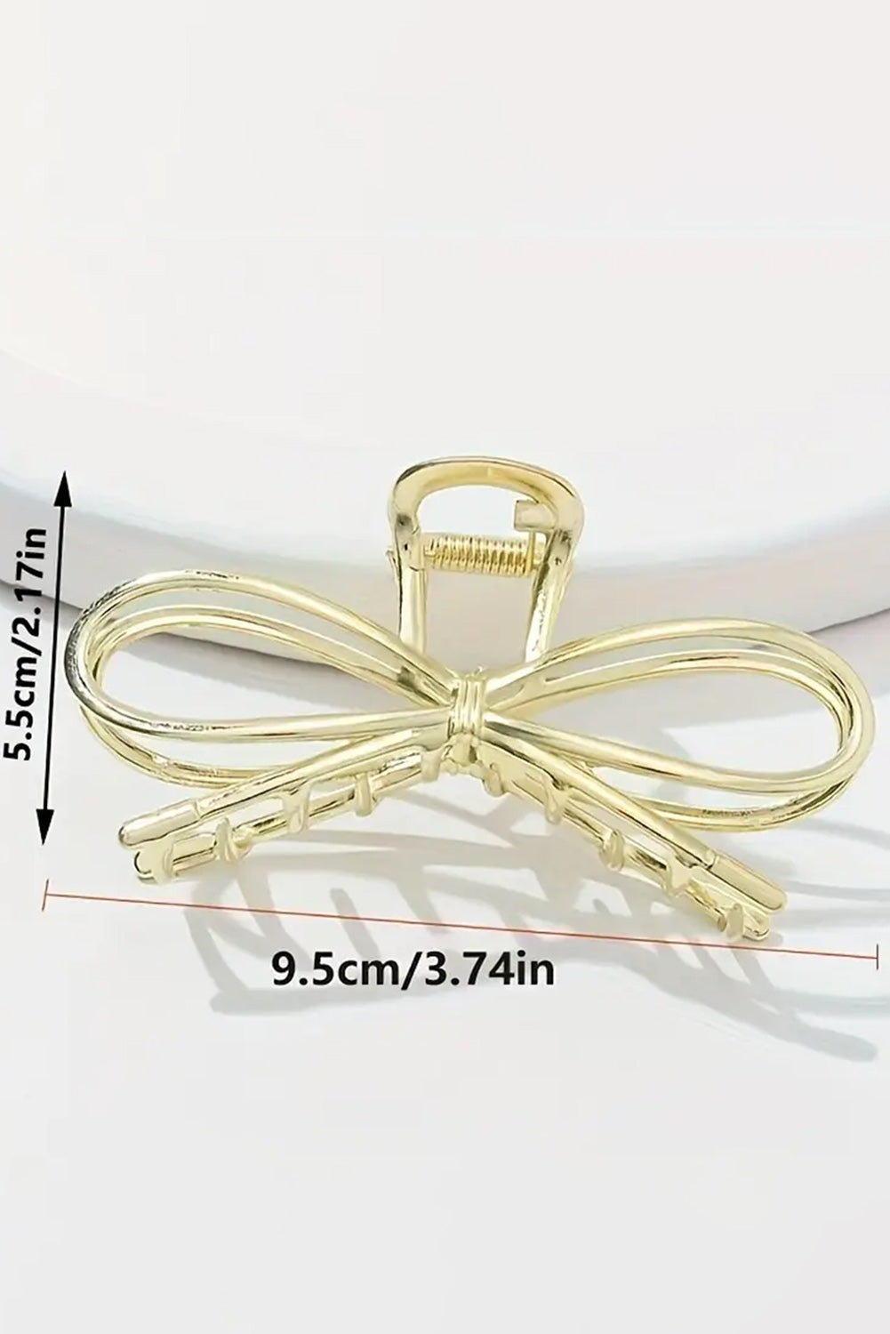 Goldene Klauenklammer in Schleifenform