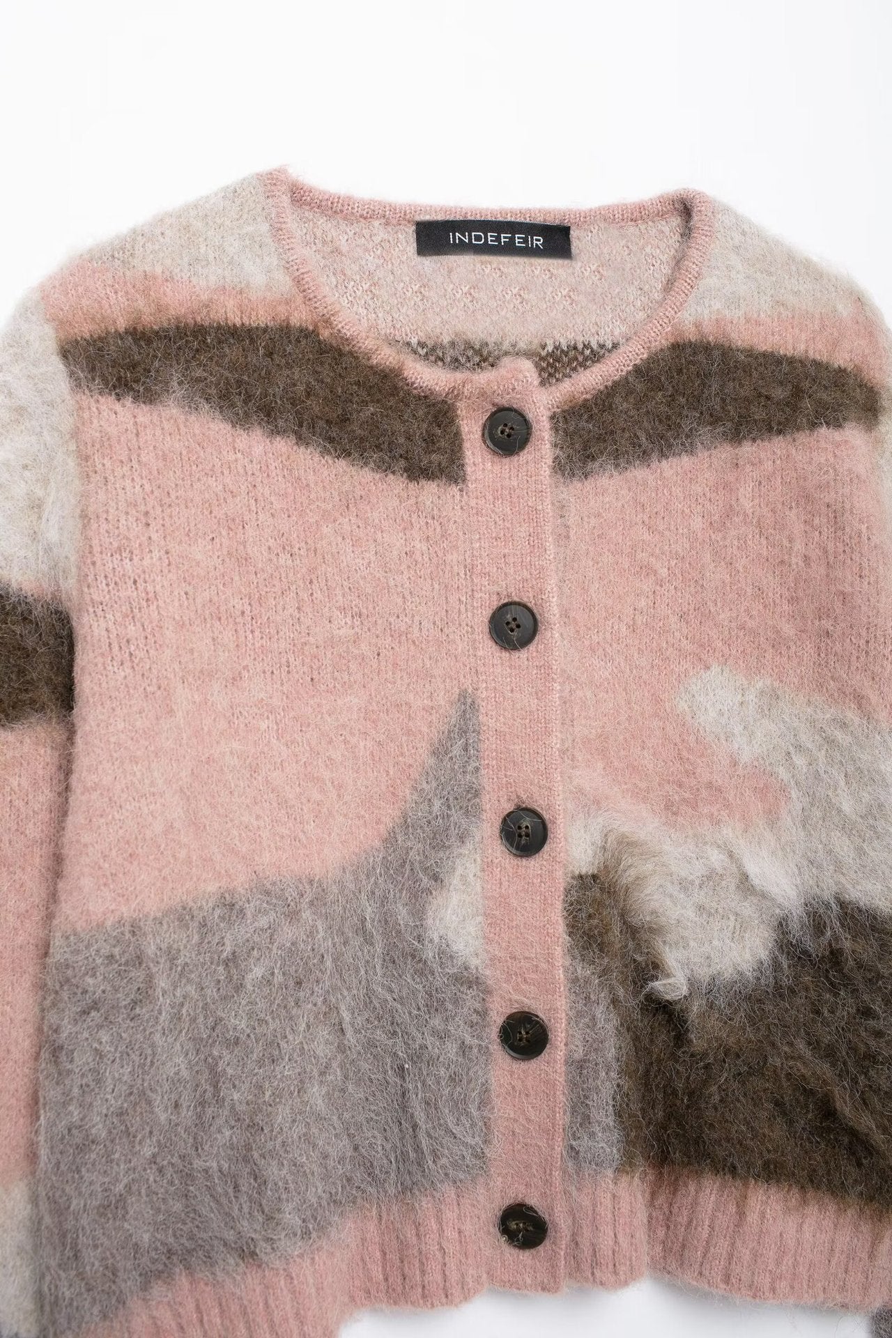 Two piece set of contrasting knitted jacket and suspender